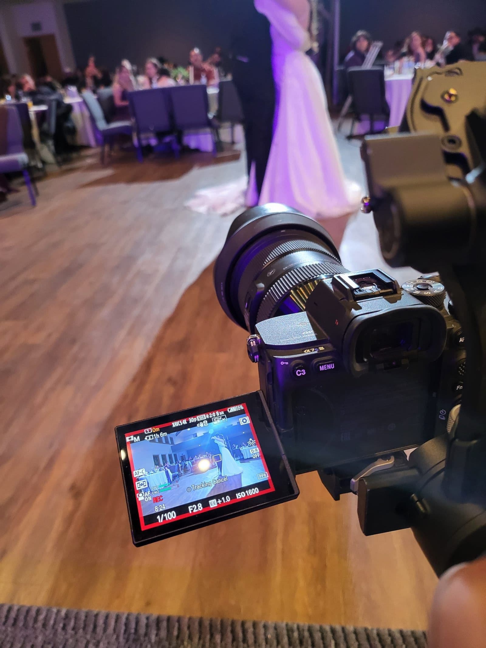 Photographer and videographer capturing wedding ceremony from different angles