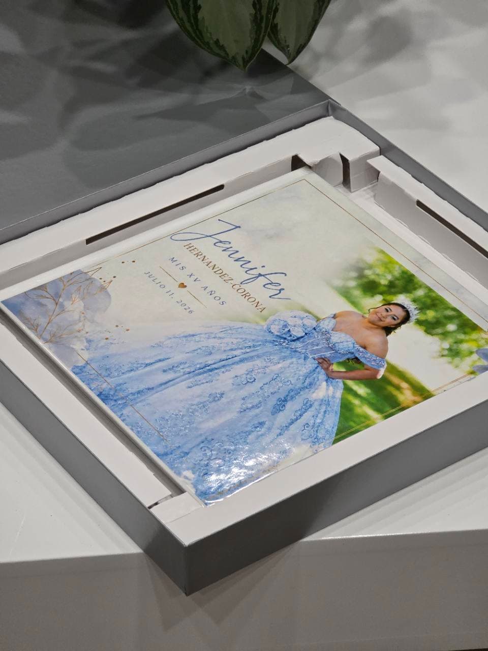 Personalized quinceañera photo album displayed inside its presentation box